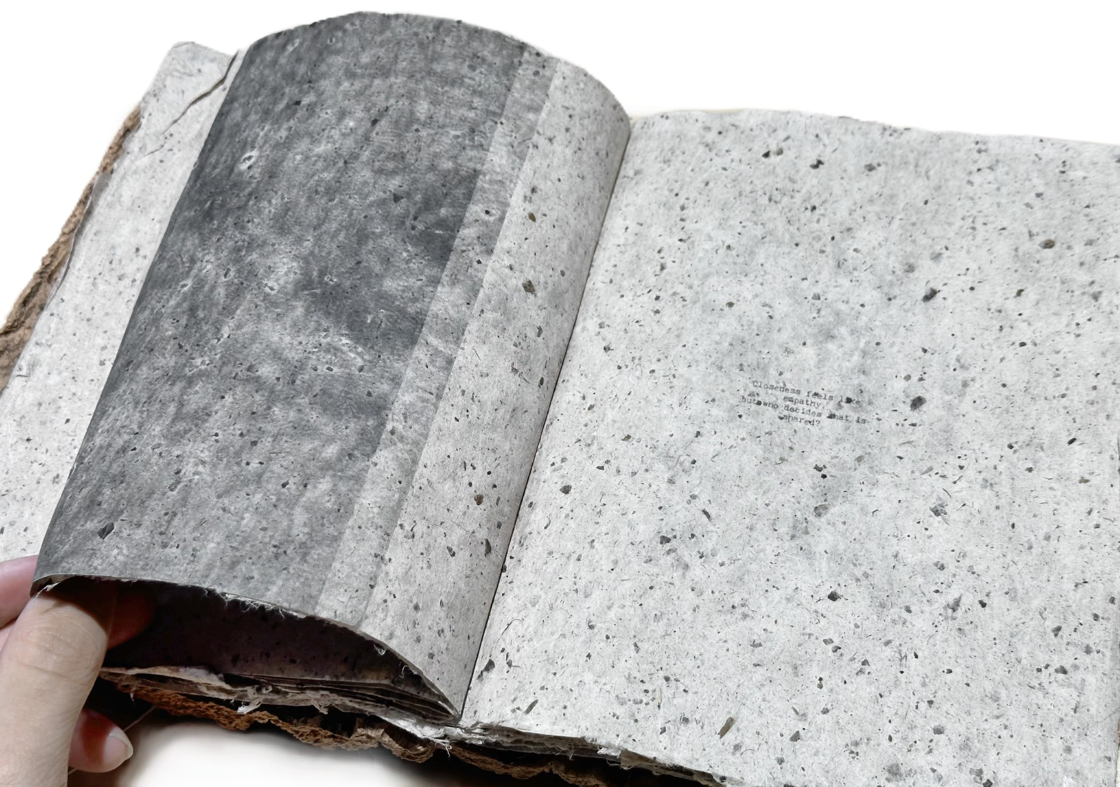Spread four — a folded sheet of pulp opens onto a stanza about closeness.